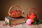 Rosehip in wicker baskets, book, rose and a teapot