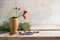 Rosehips in a stoneware vase, fir branches and scissors on a rustic wooden table for natural christmas decoration, vintage