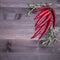 Rosemary and chili pepper, top view on brown wooden background , web banner with copy space