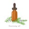 Rosemary essential oil. Amber glass dropper bottle and fragrant flowering rosemary branches