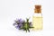 Rosemary essential oil in a small bottle. Natural aroma cosmetic oil