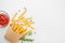 Rosemary french fries and sauce in a paper cup on a white background