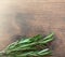 Rosemary herb bound on a wooden background with copy space. Fresh rosemary. Top view