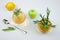 Rosemary herbal tea in glass cups, lemon, apple and tea spoon