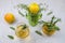Rosemary herbal tea in glass cups, lemon with thyme, apple, leaves of sage. Textured background