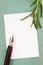 Rosemary Rosmarinus officinalis twig, white paper card and fountain pen