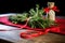 rosemary sprigs tied with a red ribbon on table