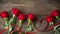 Roses and heart shaped ribbon over wooden table