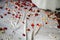 Roses petals lying on white satin background. Wedding details. Engagement proposal decoration