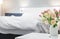 Roses in vase on background bed in edroom