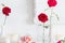 Roses in vase and candles on white background