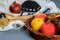 rosh hashanah jewesh holiday concept - shofar, torah book, honey, apple and pomegranate over wooden table. a kippah a yamolka