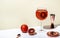 Rosso tonic alcoholic cocktail drink with red vermouth, tonic, orange and ice in wine glass. Beige background, minimalist style,