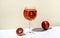 Rosso tonic alcoholic cocktail drink with red vermouth, tonic, orange and ice in wine glass. Beige background, minimalist style,