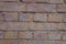 Rosy brown brick wall with paint