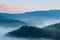 Rosy clouds and misty blue mountains