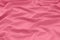 Rosy draped bright material, textile pink background