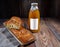 Rosy pie with orange filling, a bottle of pumpkin juice on the label place for writing, wooden table, rustic style