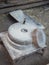 Rotary discoid mill stone for hand-grinding a grain into flour. Medieval hand-driven millstone grinding wheat. The