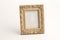 Rotary miniature wooden frames cut for photographs or paintings, photographed on a white background