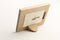 Rotary miniature wooden frames cut for photographs or paintings, photographed on a white background