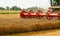 Rotary straw walker combine harvester cuts and threshes ripe wheat grain. Platform grain header with thresher reel