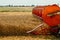 Rotary straw walker combine harvester cuts and threshes ripe wheat grain. Platform grain header with thresher reel