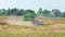 Rotary straw walker cut and threshes ripe wheat grain. Combine harvesters on field