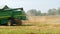 Rotary straw walker cut and threshes ripe wheat grain. Combine harvesters on field