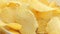 Rotate Unhealthy Harmful food, yellow delicious Potato ribbed crispy chips randomly lying on a white table background, close-up fo
