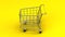 Rotated Shopping Cart On Yellow Background