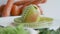 Rotating apple with measurement tape on a plate. Vegetables on the background.