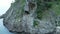 Rotating around small shrine in cave on rocky cliff at Sea of Japan coast