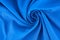 Rotating blue knitted cotton fabric background