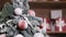 Rotating Christmas tree with red toys, balls on a background of gifts boxes.