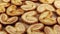 Rotating close up of fresh palm puff pastry in the shape of a heart. French biscuits with elephant ears. View from above. Close-up