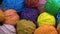 Rotating colorful balls of yarn background