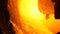 Rotating furnace in factory. Stock footage. Close-up of incandescent material spreading in rotating furnace in factory