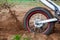 Rotating rear wheel of cross-country motorcycle with flying mud from tire