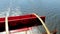 Rotating red paddle wheel of a cruise boat in motion