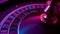 Rotating roulette wheel close up in the rays of purple neon lights. The small white ball hits red 14, the bet wins. Part