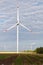 Rotating wind turbines against the cloudy sky