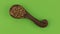 Rotation and approach of the spoon with buckwheat grains, green screen.