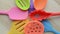 Rotation of bright multi colored kitchen utensils on wooden background