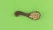 Rotation of a clay spoon with barley grain. Chroma key.