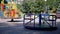 Rotation of an Empty Multicolored Carousel on a Playground in a City Park