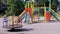 Rotation of an Empty Multicolored Carousel on a Playground in a City Park. 4K