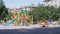 Rotation of an Empty Multicolored Carousel on a Playground in a City Park. 4K