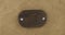 Rotation of an oval wooden board with iron bolts on sackcloth. Empty frame. Top view