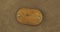 Rotation of an oval wooden board with iron bolts on sackcloth. Empty frame. Top view